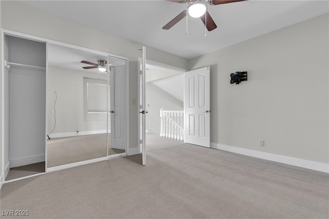 unfurnished bedroom featuring a closet, ceiling fan, and light carpet