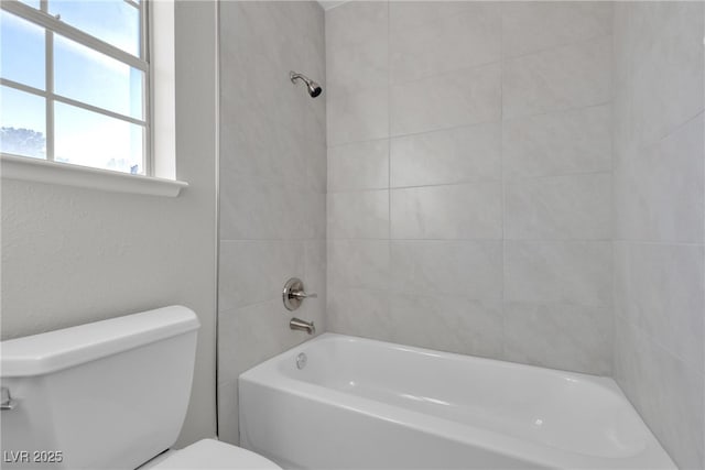 bathroom featuring toilet and shower / tub combination