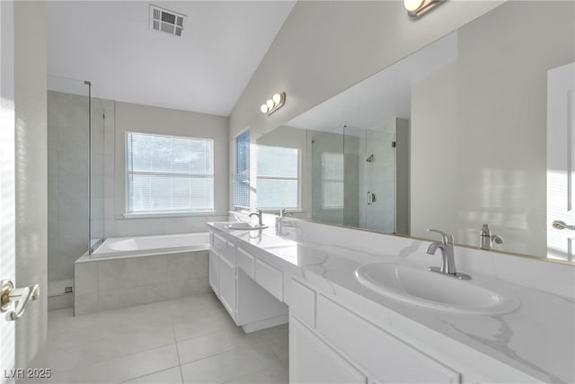 bathroom with vanity, shower with separate bathtub, tile patterned floors, and lofted ceiling