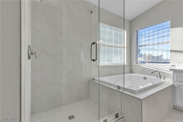 bathroom featuring shower with separate bathtub