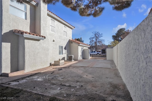 view of home's exterior featuring a patio area and central AC unit