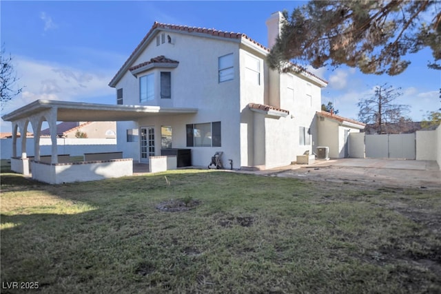 rear view of property featuring a patio area, central AC, and a yard