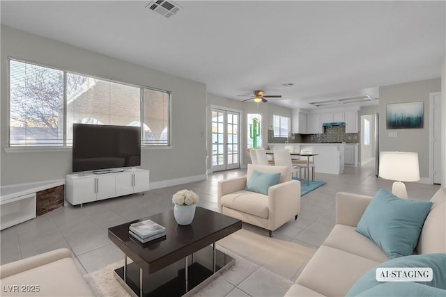 living room featuring ceiling fan and light tile patterned floors