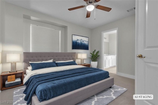 carpeted bedroom with ceiling fan and ensuite bath