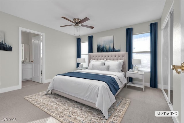 carpeted bedroom with ensuite bath and ceiling fan