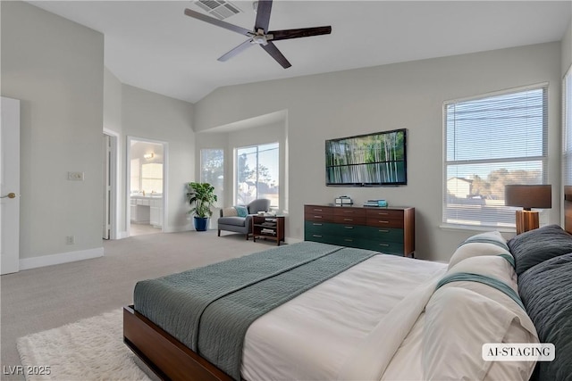 bedroom with ceiling fan, ensuite bathroom, light carpet, and lofted ceiling