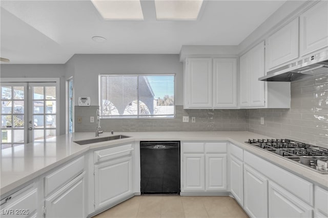 kitchen featuring stainless steel gas stovetop, tasteful backsplash, dishwasher, white cabinets, and sink