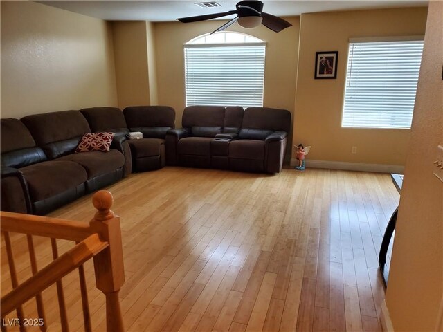 living room featuring ceiling fan and light wood-type flooring