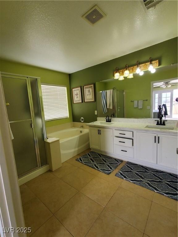 bathroom with ceiling fan, vanity, a textured ceiling, tile patterned floors, and shower with separate bathtub