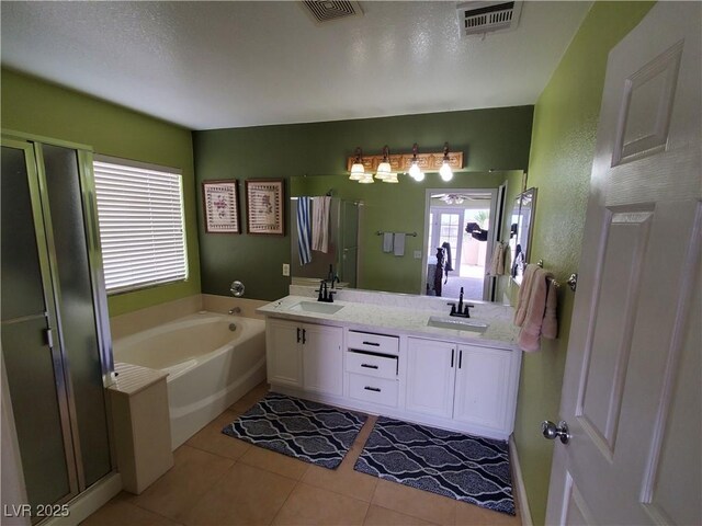 bathroom with vanity, tile patterned floors, and plus walk in shower