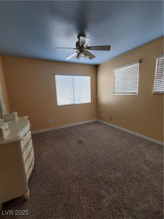 spare room with ceiling fan, carpet floors, and a textured ceiling