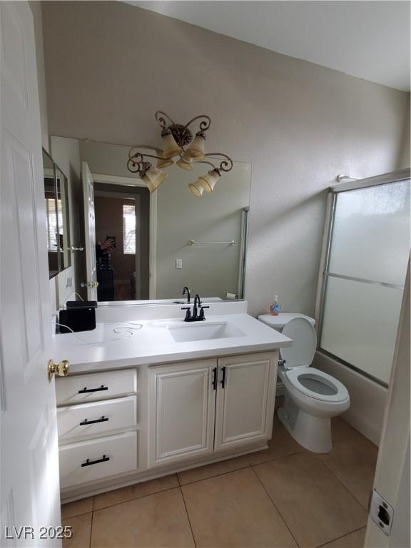 full bathroom featuring enclosed tub / shower combo, vanity, ceiling fan, toilet, and tile patterned floors