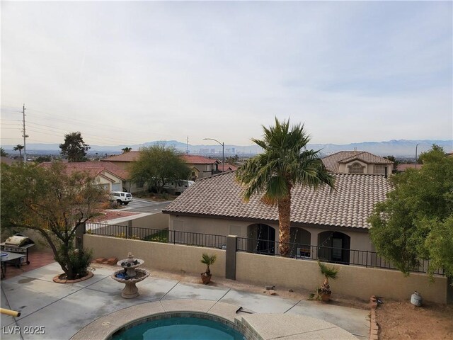 view of pool featuring a mountain view and a patio