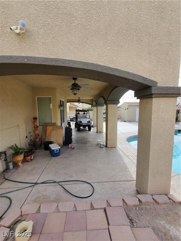 view of patio featuring ceiling fan