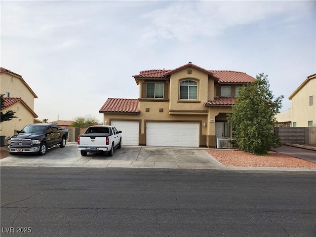 mediterranean / spanish home with a garage