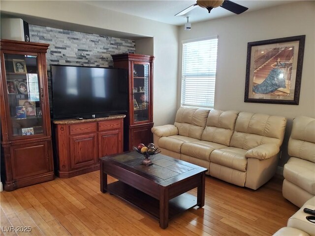 living room with ceiling fan and light hardwood / wood-style floors