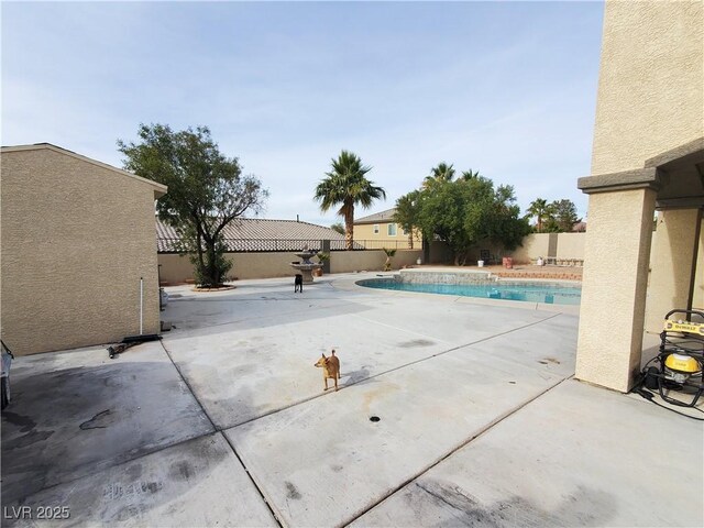 view of swimming pool featuring a patio area