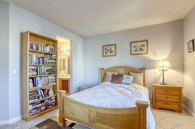 bedroom with light tile patterned floors and ensuite bath