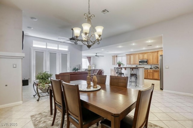 dining area featuring ceiling fan with notable chandelier and light tile patterned floors