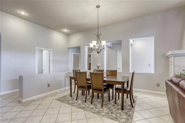 dining space featuring light tile patterned floors and a notable chandelier