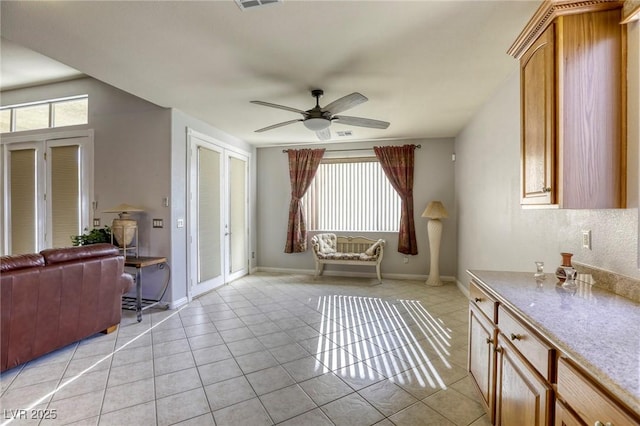 unfurnished room with ceiling fan and light tile patterned floors