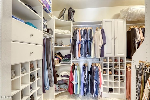 spacious closet featuring light tile patterned floors