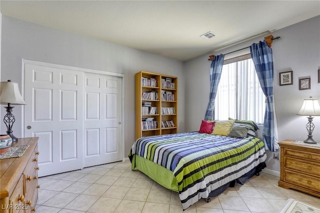 tiled bedroom with a closet