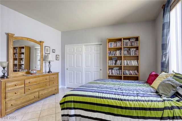 tiled bedroom with a closet