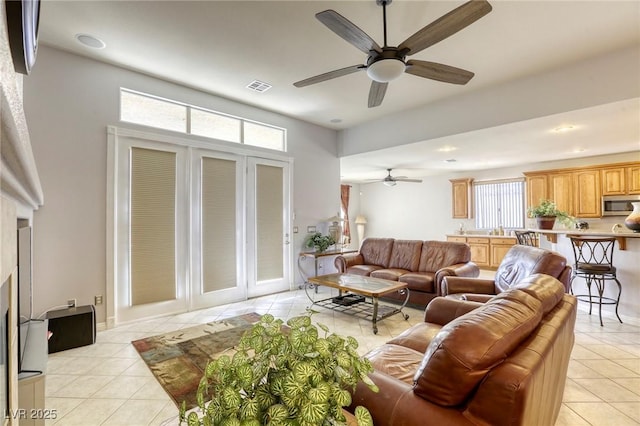 tiled living room with ceiling fan