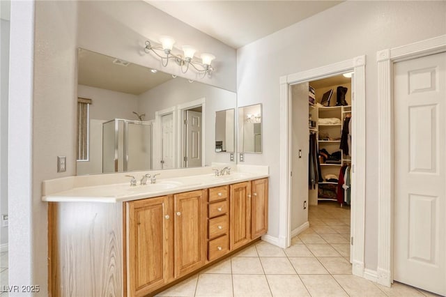 bathroom featuring a shower with door, vanity, and tile patterned flooring