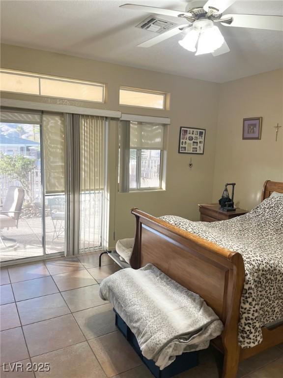 bedroom with light tile patterned floors, access to outside, and ceiling fan