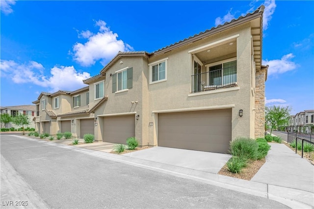 townhome / multi-family property with a garage and a balcony