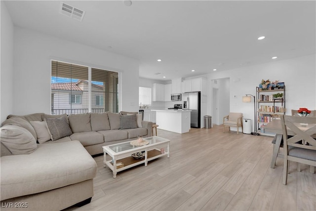 living room with light hardwood / wood-style flooring