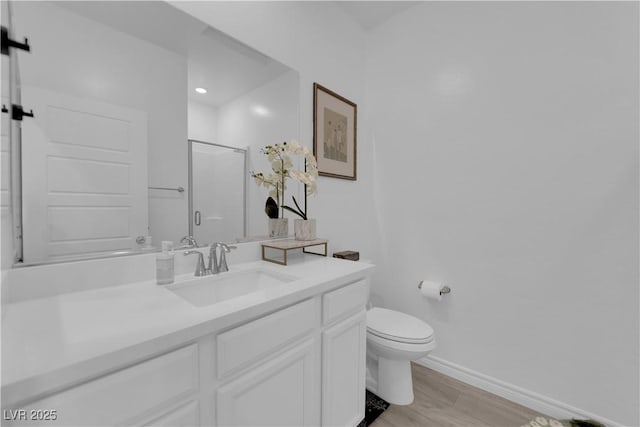 bathroom featuring hardwood / wood-style floors, vanity, toilet, and an enclosed shower