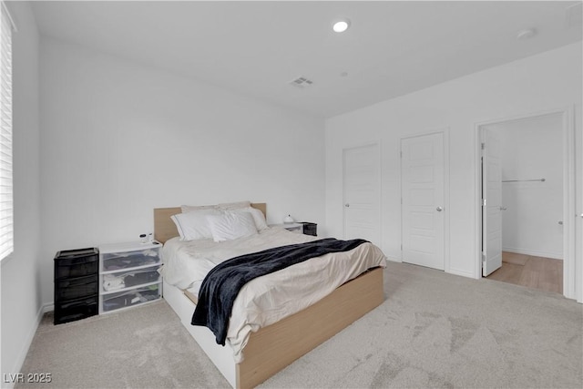 bedroom featuring light carpet