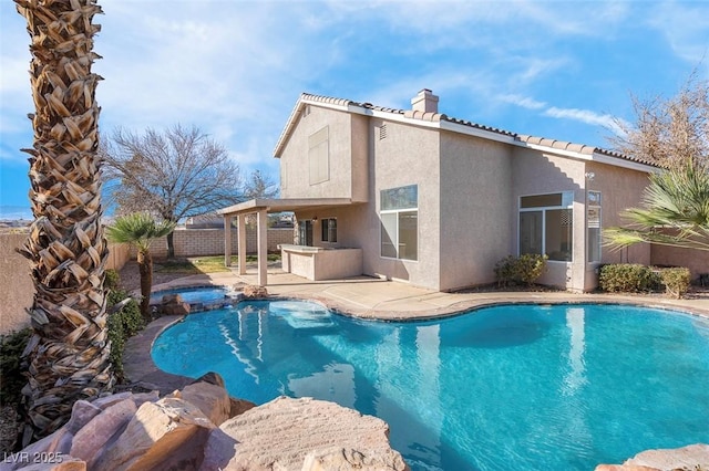 view of swimming pool with a patio area and an in ground hot tub