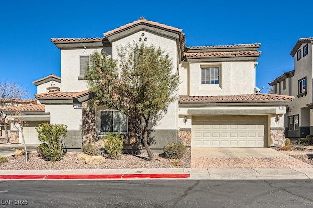 mediterranean / spanish-style house with a garage