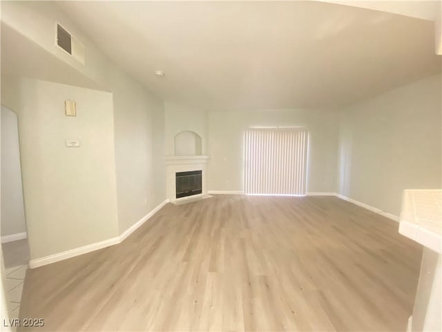 unfurnished living room featuring light hardwood / wood-style flooring