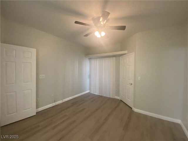 unfurnished room featuring dark hardwood / wood-style floors and ceiling fan