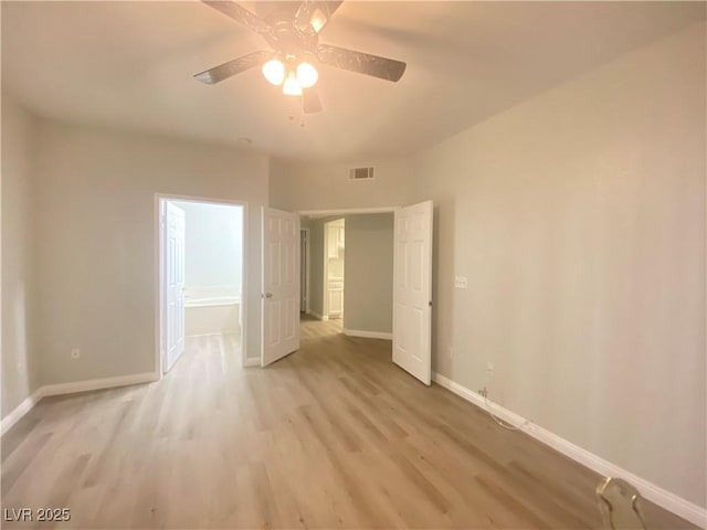 spare room with light hardwood / wood-style flooring and ceiling fan