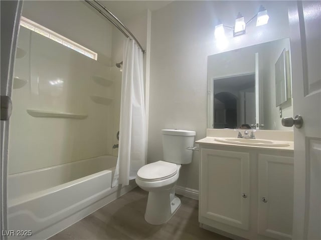 full bathroom with hardwood / wood-style floors, vanity, toilet, and shower / tub combo with curtain