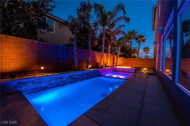 view of pool at night