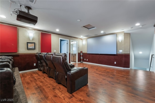 cinema room featuring crown molding and dark wood-type flooring