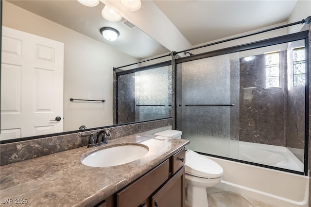 full bathroom featuring tile patterned flooring, vanity, toilet, and bath / shower combo with glass door