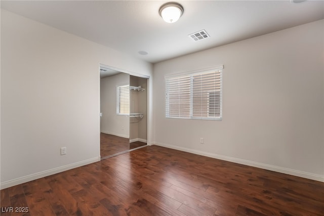 spare room featuring dark hardwood / wood-style floors