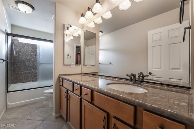 full bathroom featuring toilet, tile patterned flooring, vanity, and combined bath / shower with glass door