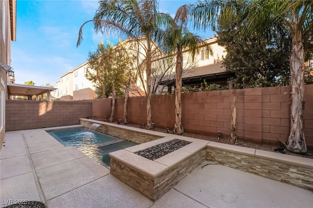 view of swimming pool with pool water feature, a patio, and a fire pit