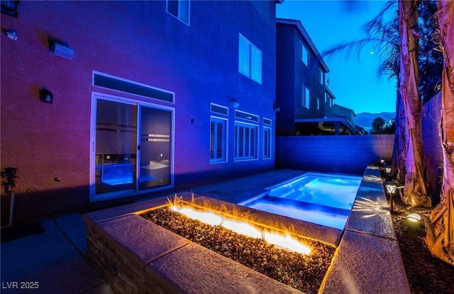 view of swimming pool with an outdoor fire pit