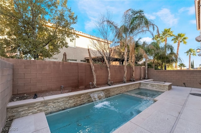 view of swimming pool featuring pool water feature and an in ground hot tub