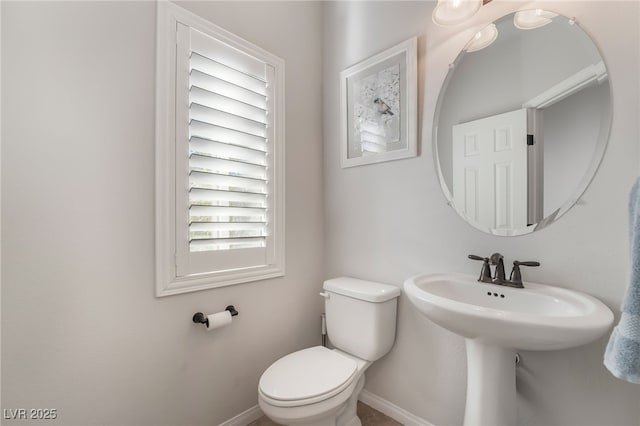 bathroom featuring toilet and a wealth of natural light